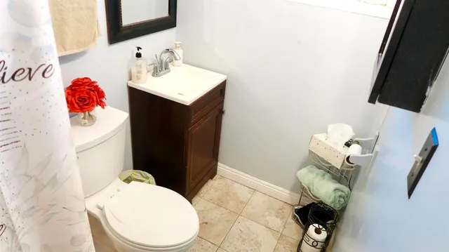 a bathroom with a sink toilet and mirror