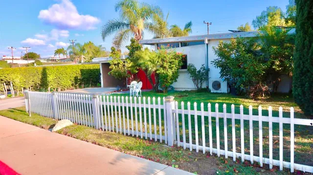 a view of a park with a large trees