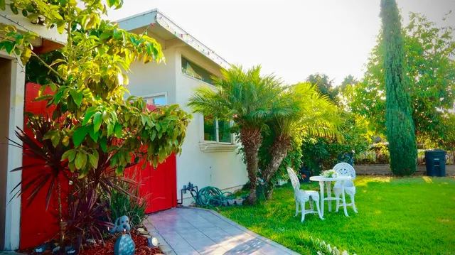 a view of a chair and table in the garden