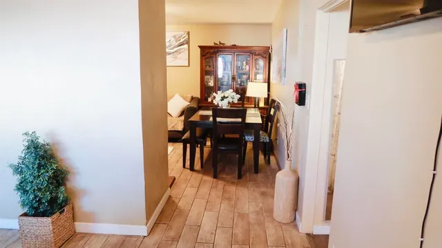 a dining room with furniture and wooden floor