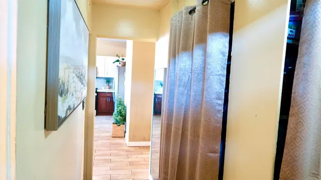 a view of a bathroom from a corridor