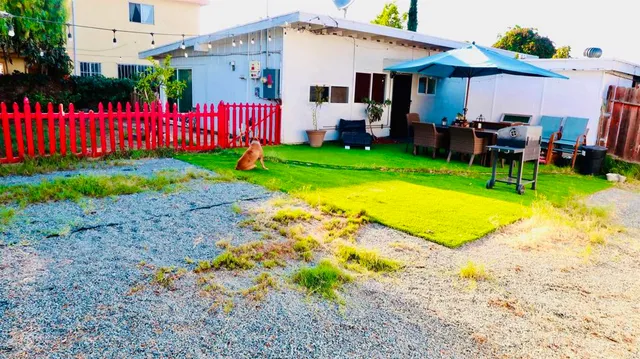a front view of house with yard and swimming pool