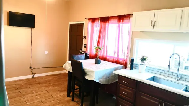 a kitchen with a sink cabinets and wooden floor