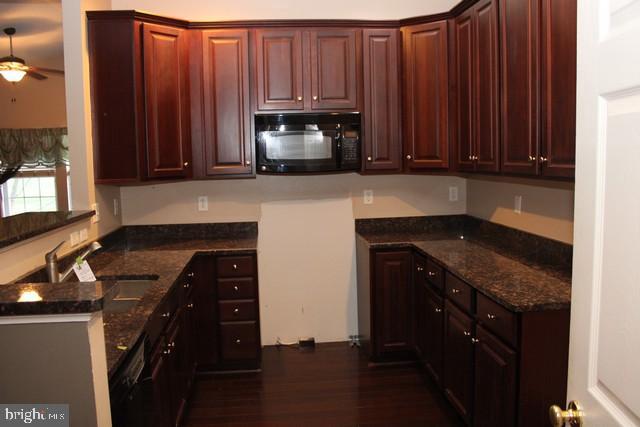 3309 Portrait Way Chambersburg, PA 17202 - Photo 2 of 16 a kitchen with wooden cabinets and a stove top oven