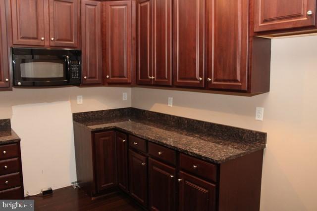 3309 Portrait Way Chambersburg, PA 17202 - Photo 3 of 16 a kitchen with granite countertop wooden cabinets and a sink
