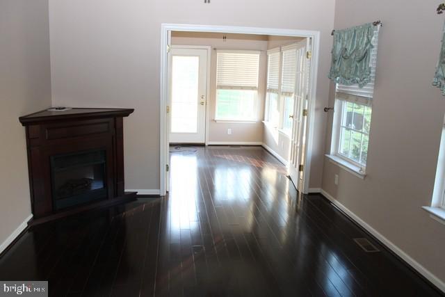 3309 Portrait Way Chambersburg, PA 17202 - Photo 6 of 16 a view of a hallway with wooden floor and a fireplace