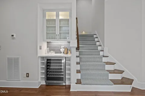 a room view with wooden floor and electronic appliances