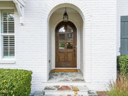 a kitchen with a dining table chairs refrigerator and cabinets