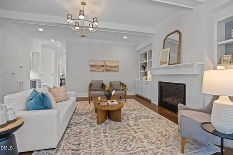 a view of a dining room with furniture a chandelier and wooden floor