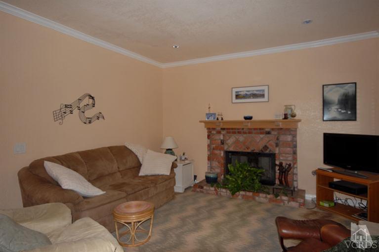 761 Coronado Place Oxnard, CA 93030 - Photo 11 of 27 a living room with furniture a flat screen tv and a fireplace