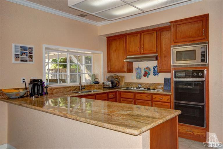 761 Coronado Place Oxnard, CA 93030 - Photo 13 of 27 a kitchen with stainless steel appliances granite countertop a sink stove and refrigerator