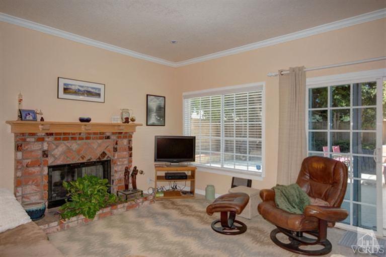 761 Coronado Place Oxnard, CA 93030 - Photo 10 of 27 a living room with furniture a fireplace and a flat screen tv