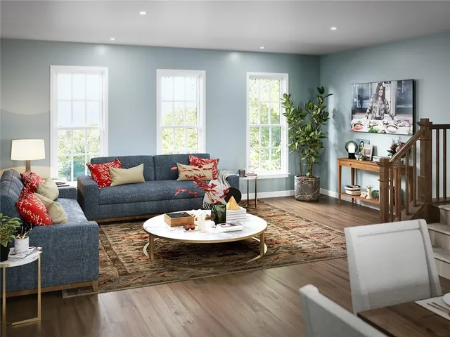 a living room with furniture and a dining table with wooden floor