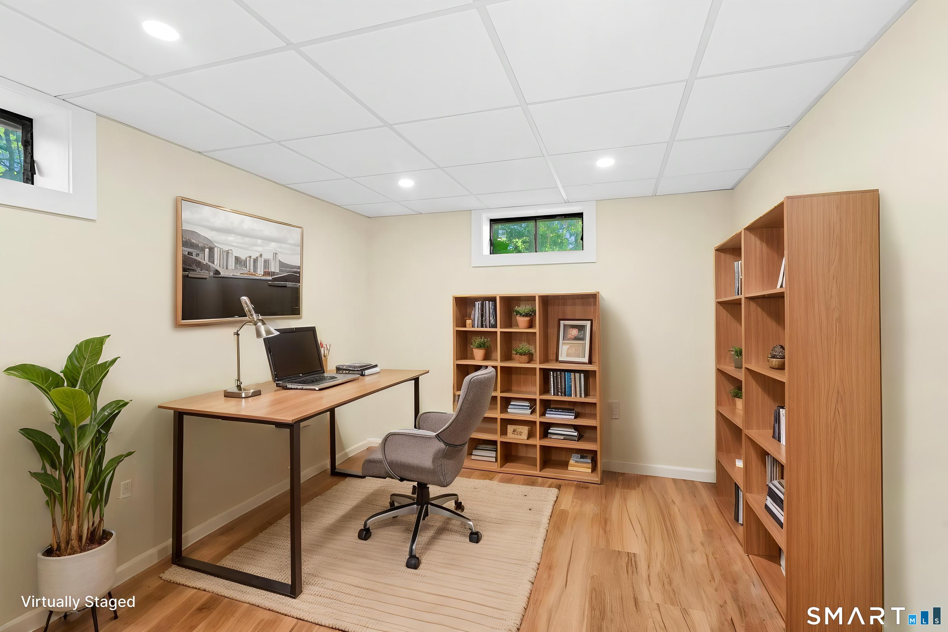 140 Spring Street Stratford, CT 06614 - Photo 22 of 29 a view of a workspace with furniture and bookshelf