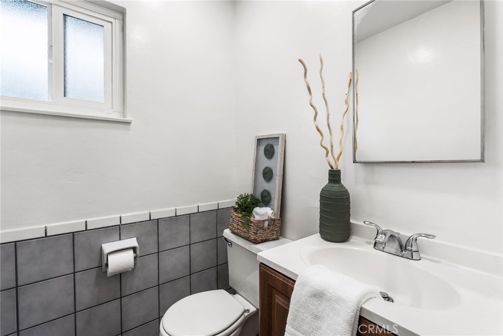 13361 Roxey Drive Garden Grove, CA 92843 - Photo 13 of 31 a bathroom with a sink toilet and mirror