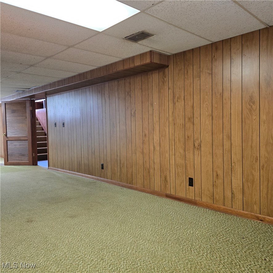 2317 Liberty Road Stow, OH 44224 - Photo 22 of 29 Finished below grade area featuring a drop ceiling, wood walls, carpet floors and movable closet storage space
