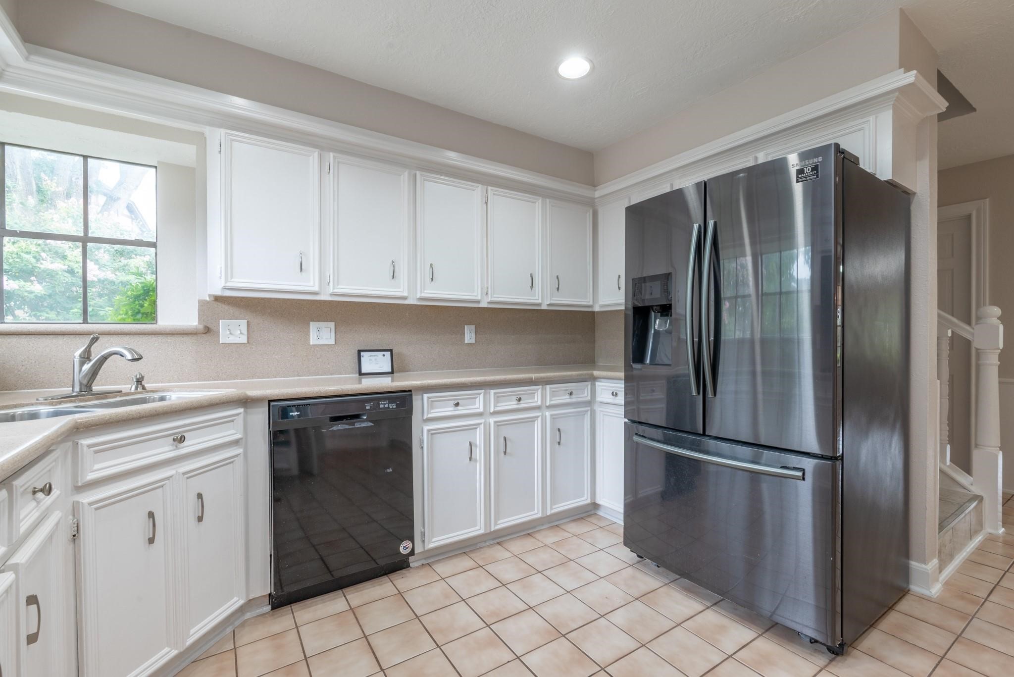 8019 Beaufort Drive Spring, TX 77379 - Photo 20 of 47 a kitchen with a refrigerator sink and cabinets