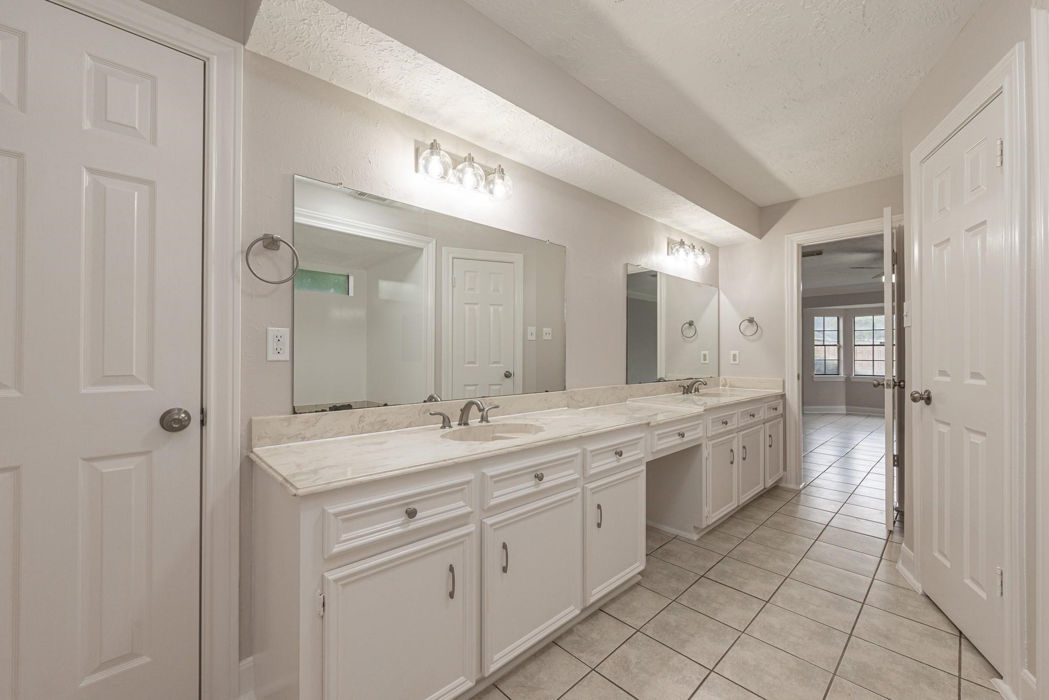 8019 Beaufort Drive Spring, TX 77379 - Photo 26 of 47 a spacious bathroom with a granite countertop sink mirror and