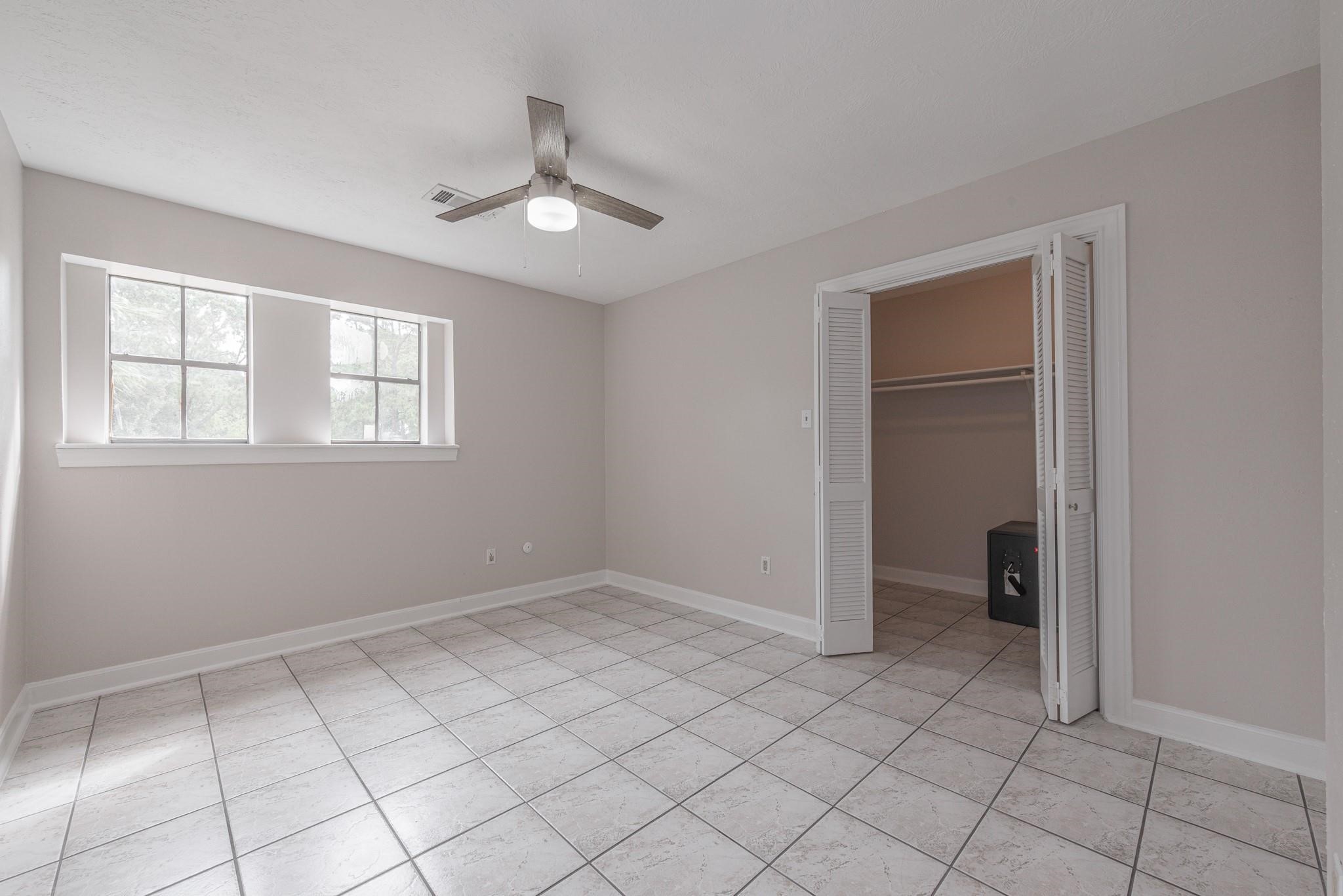 8019 Beaufort Drive Spring, TX 77379 - Photo 37 of 47 a view of an empty room with window and chandelier fan
