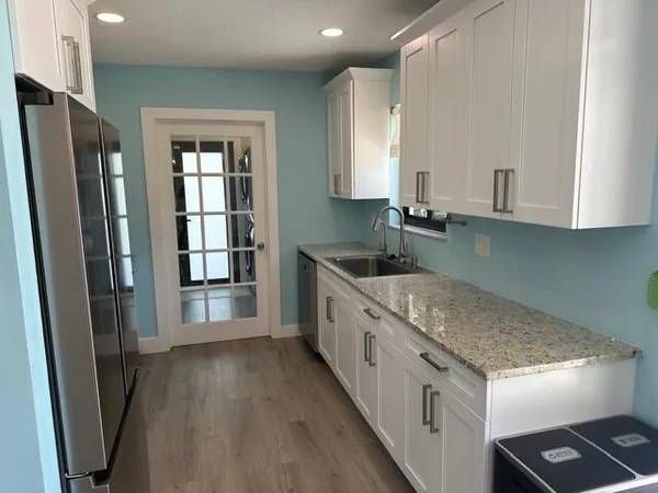 a kitchen with stainless steel appliances granite countertop a sink stove and refrigerator
