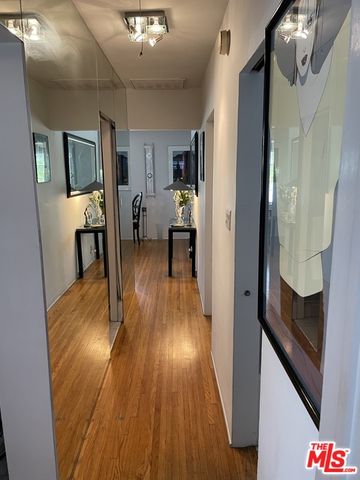 a view of a hallway view with wooden floor and staircase