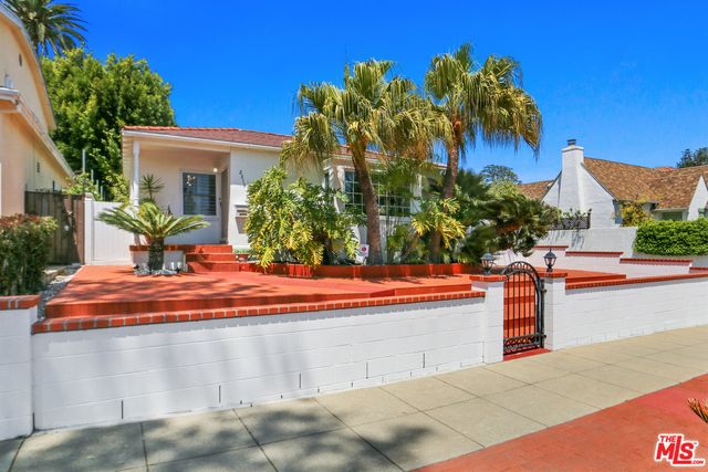a swimming pool with outdoor seating and trees