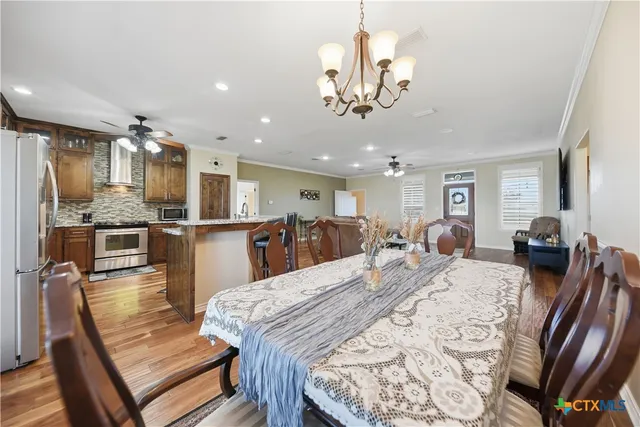 a large kitchen with a table and chairs
