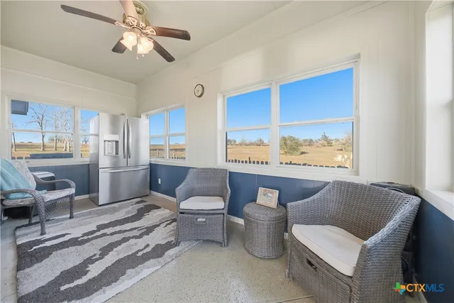 a living room with hard wood floors and a window