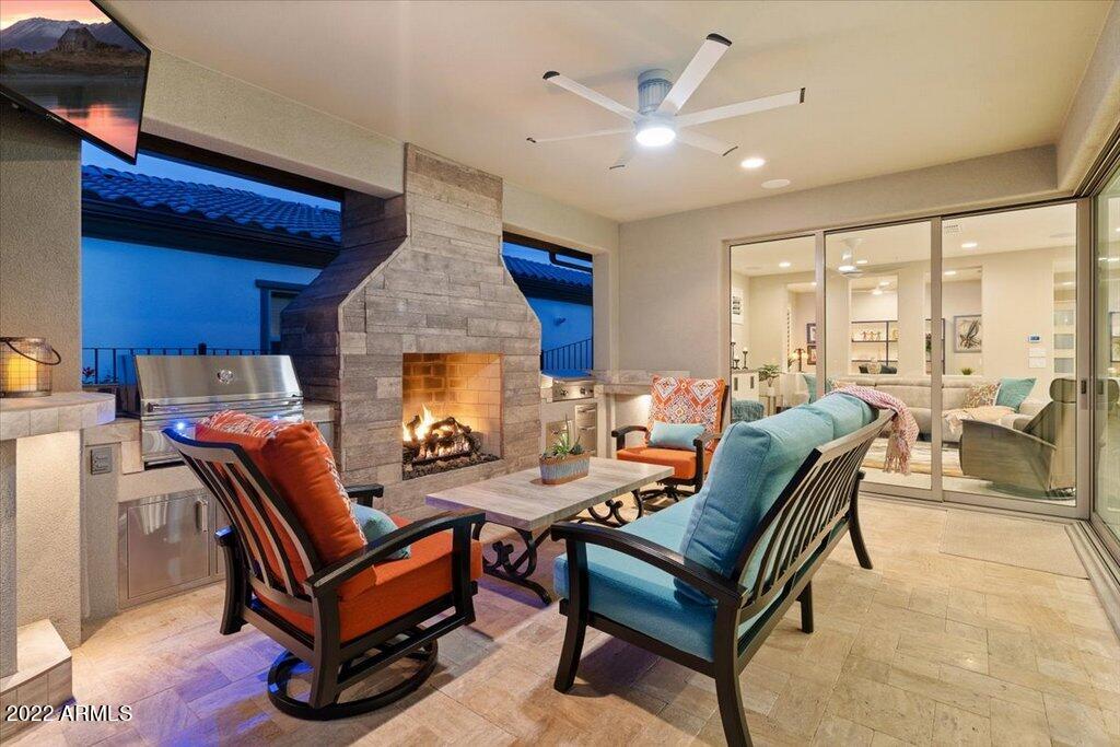 17860 East Cindercone Road Rio Verde, AZ 85263 - Photo 29 of 60 a outdoor living space with furniture a fireplace and a ceiling fan