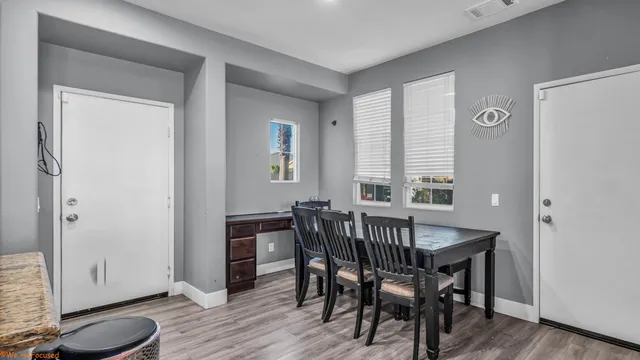 a view of a dining room with furniture and wooden floor
