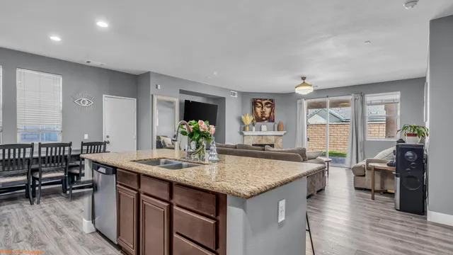 a view of living room with granite countertop furniture and wooden floor