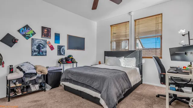 a bedroom with a bed and a desk