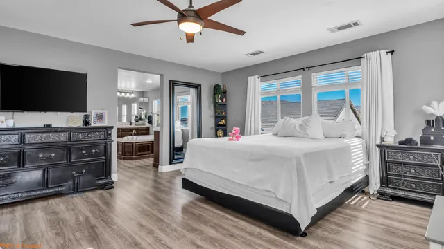 a bedroom with a bed and a flat screen television