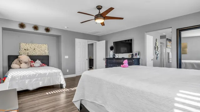 a bedroom with a bed and a large mirror