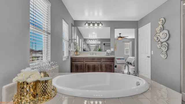 a bathroom with a tub sink and mirror