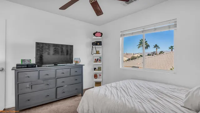 a bedroom with a bed and a flat screen tv in a dresser