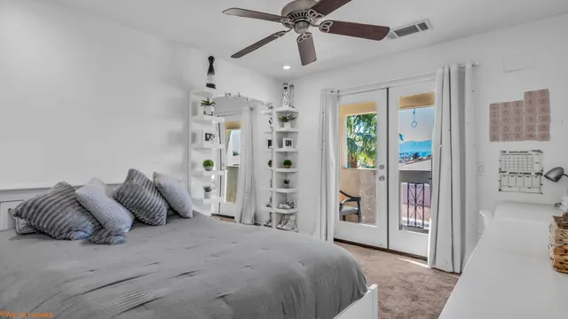 a bedroom with a large bed and a chandelier