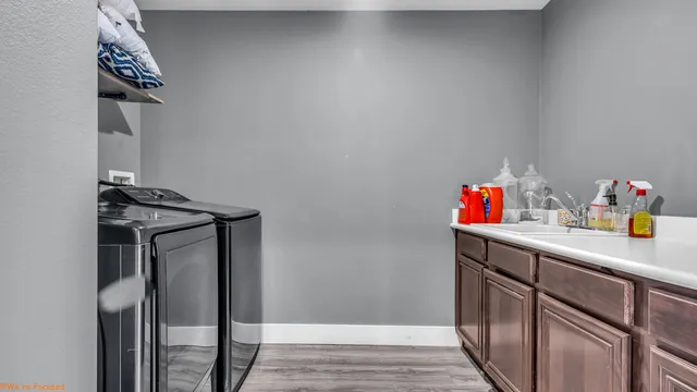a utility room with sink dryer and washer