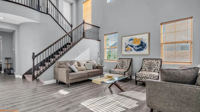 a living room with furniture and a wooden floor