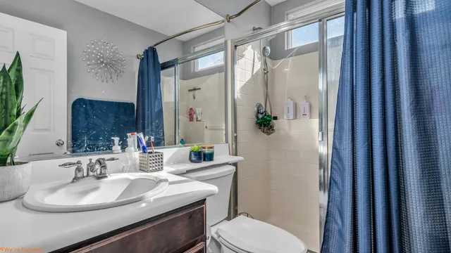 a bathroom with a sink toilet and shower