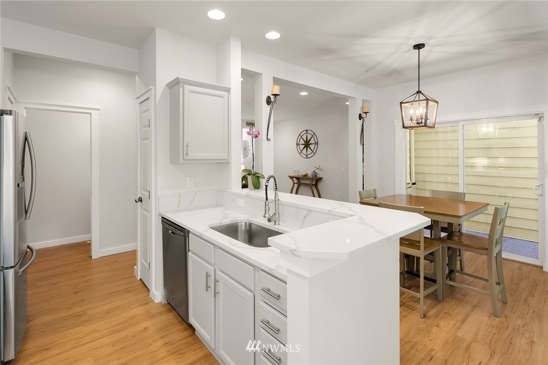 21325 11th Drive Southeast Bothell, WA 98021 - Photo 11 of 27 a kitchen with a sink appliances and a dining table