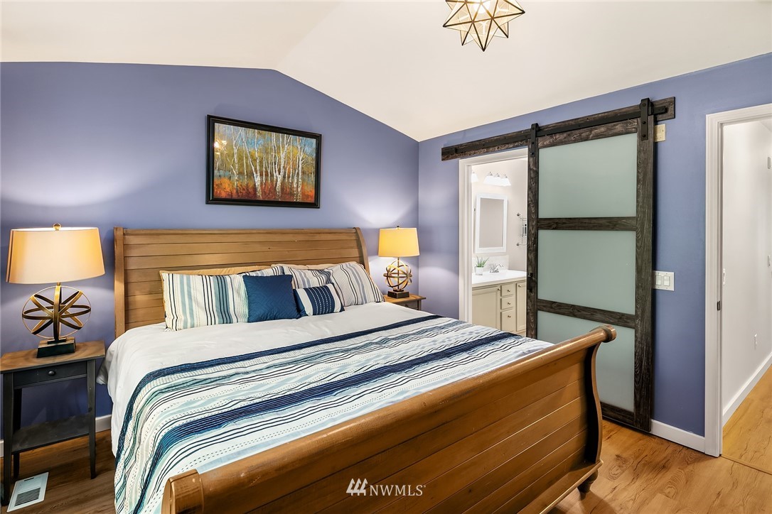 21325 11th Drive Southeast Bothell, WA 98021 - Photo 18 of 27 a bedroom with a bed and a painting on the wall