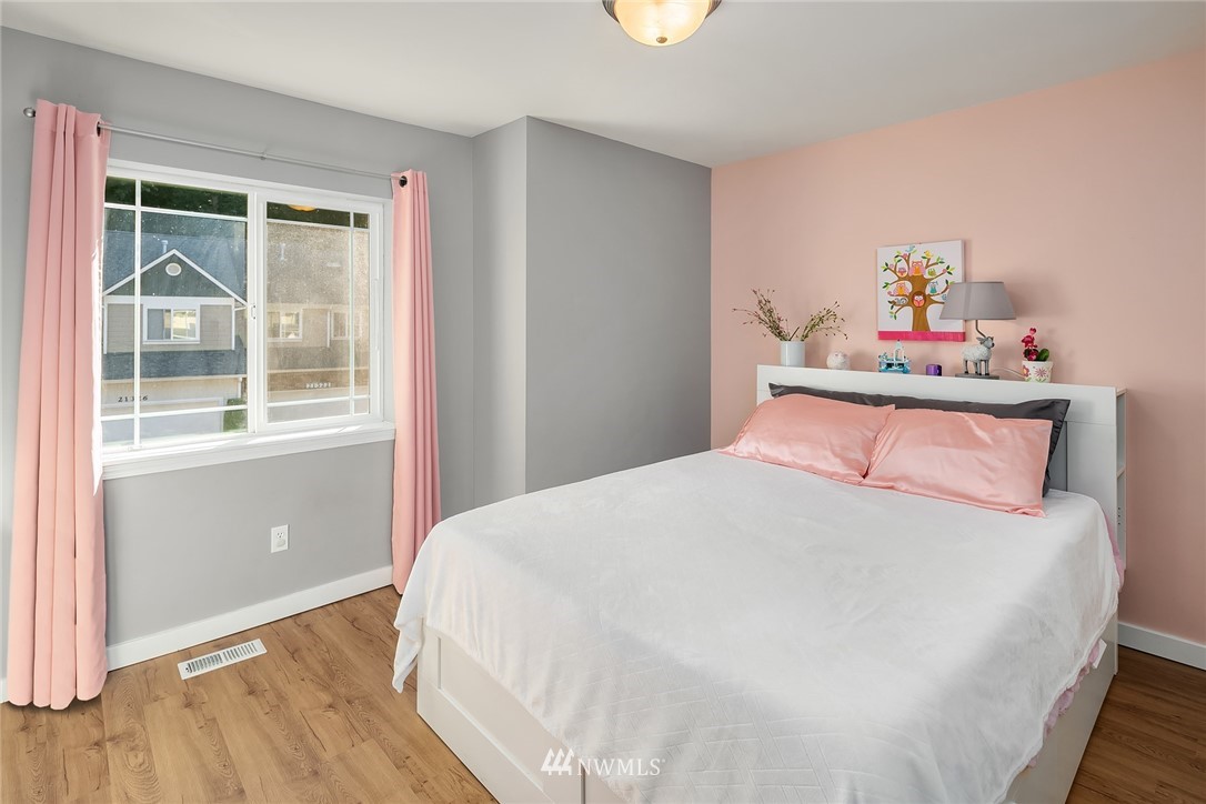 21325 11th Drive Southeast Bothell, WA 98021 - Photo 22 of 27 a bedroom with a bed and wooden floor
