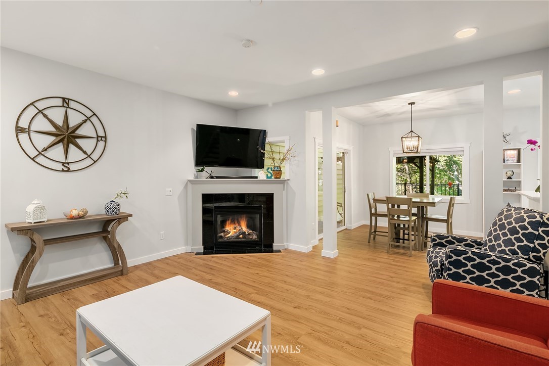 21325 11th Drive Southeast Bothell, WA 98021 - Photo 7 of 27 a living room with furniture a fireplace and a flat screen tv