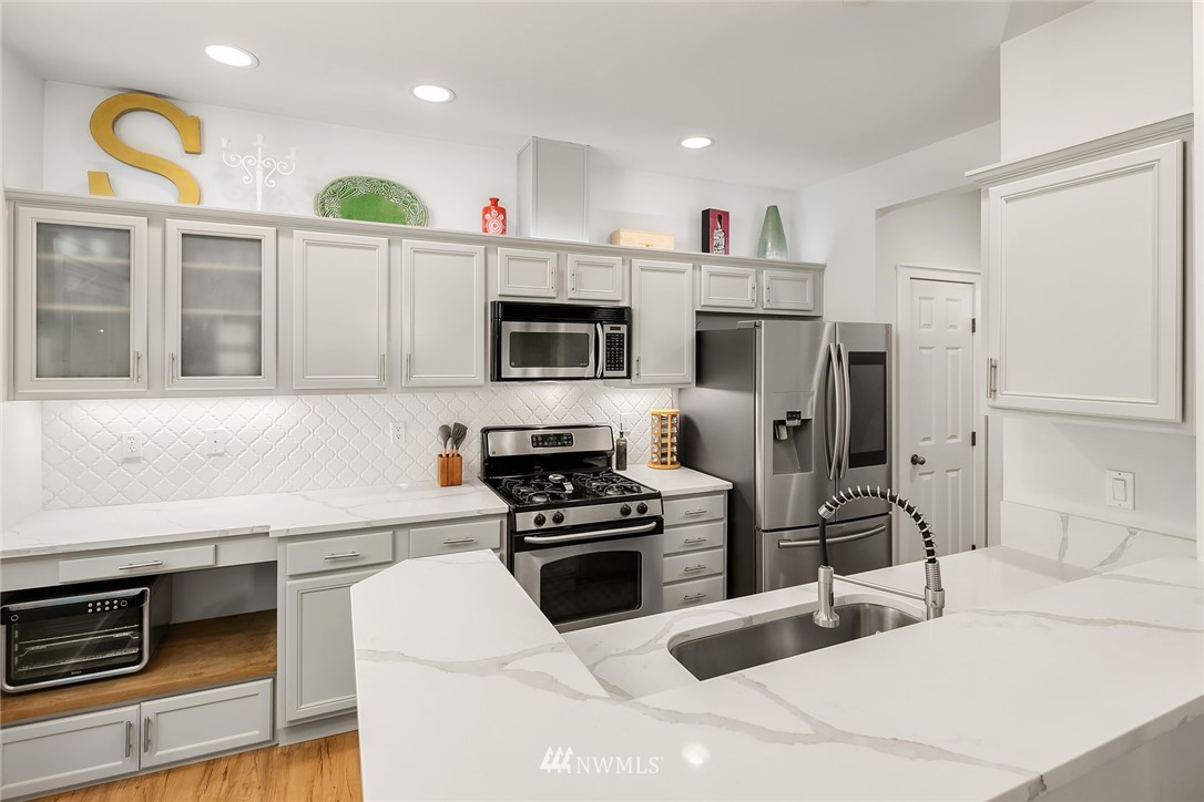 21325 11th Drive Southeast Bothell, WA 98021 - Photo 10 of 27 a kitchen with a sink stainless steel appliances and cabinets