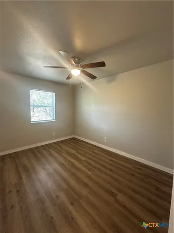 a kitchen with granite countertop a sink stove and refrigerator