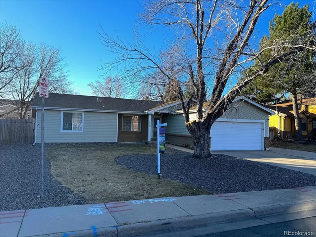 a view of a house with a tree and a yard