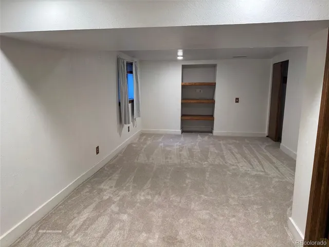 a view of an empty room with a closet