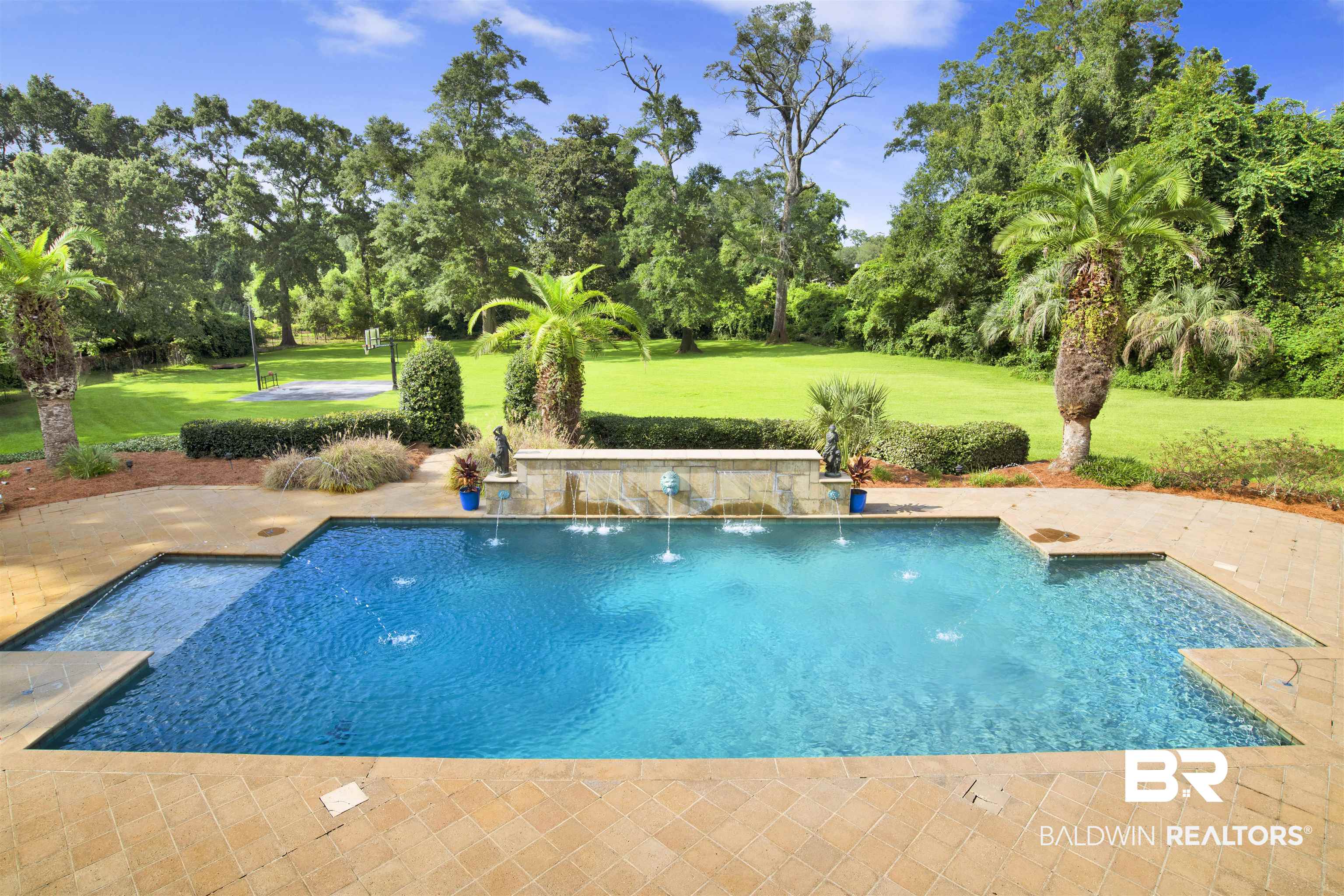 3816 Austill Lane Mobile, AL 36608 - Photo 62 of 80 Outdoor pool with a lawn, view of wooded area, and a patio