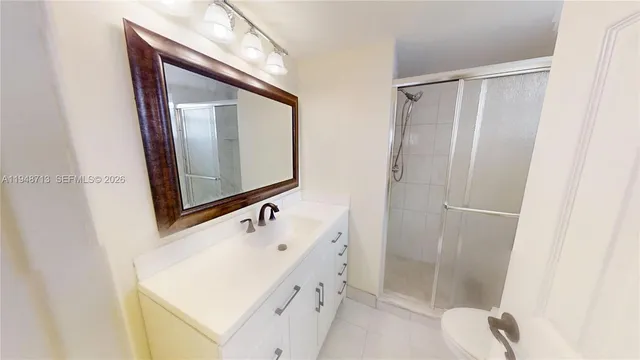 a bathroom with a sink a mirror and a shower
